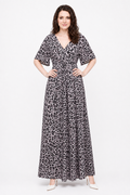 Zena wearing the Avamia River Maxi Dress in pale leopard print, front view with hands on hips