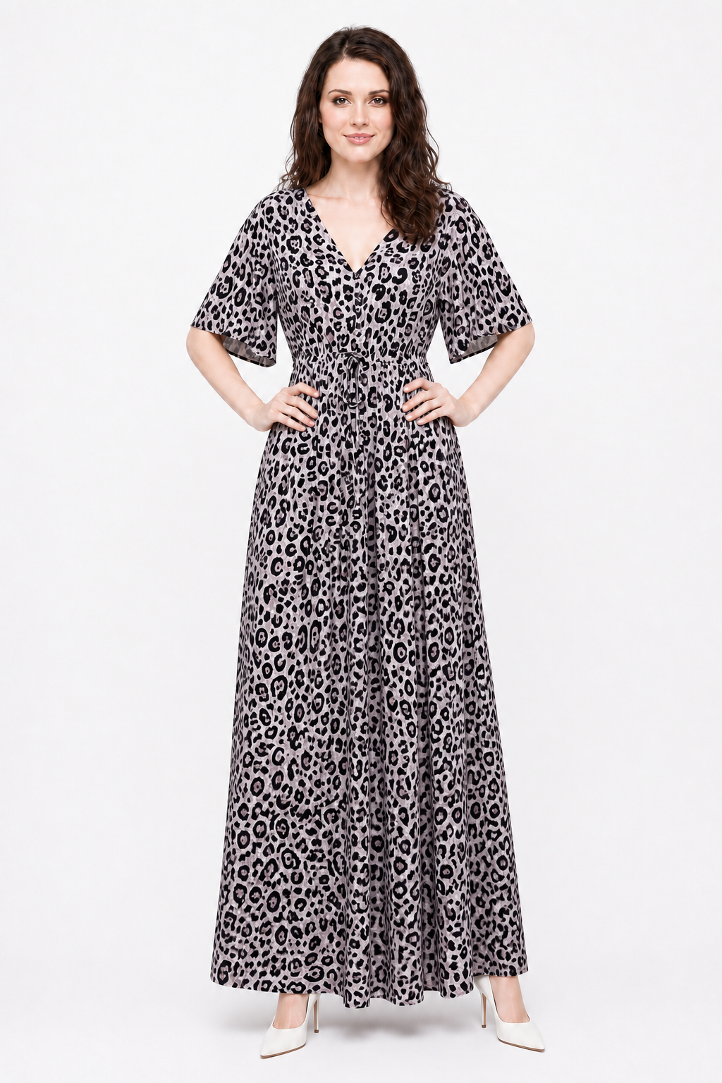 Zena wearing the Avamia River Maxi Dress in pale leopard print, front view with hands on hips