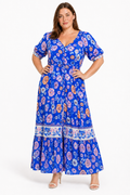 Jia wearing the Lavinia Dream blue floral maxi dress, front view with hands on hips