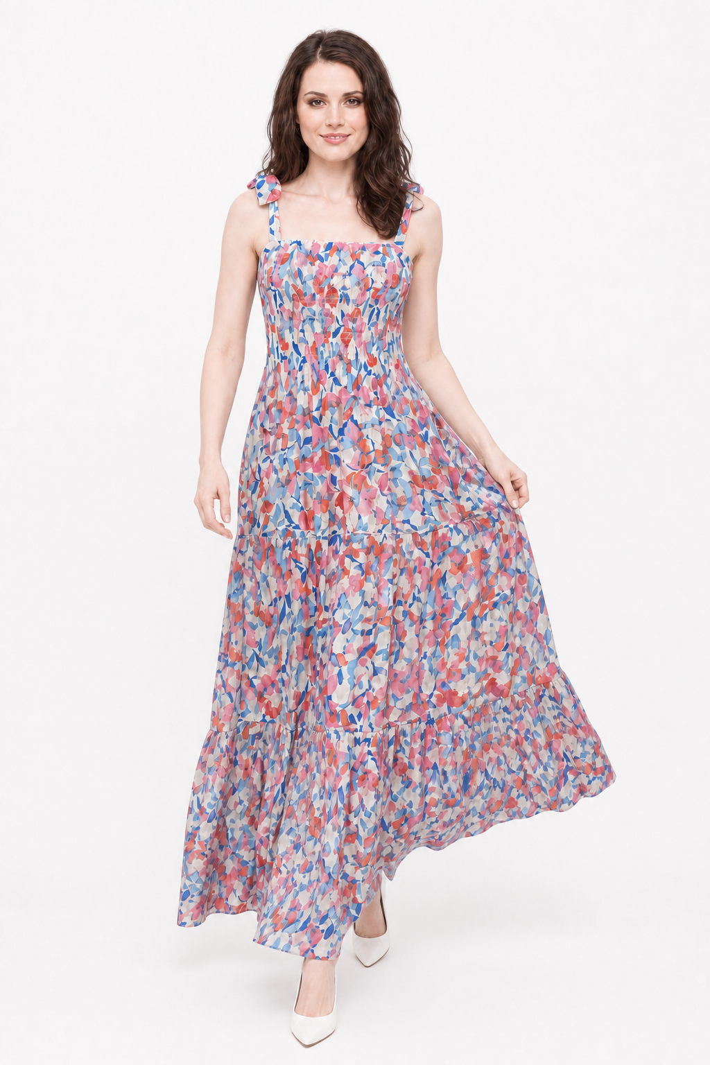 Cherry Blossom Maxi on Zena walking and lightly lifting the skirt in a white studio.