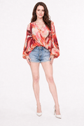 Love Me Lily floral wrap top front view with Zena in denim shorts and white heels.
