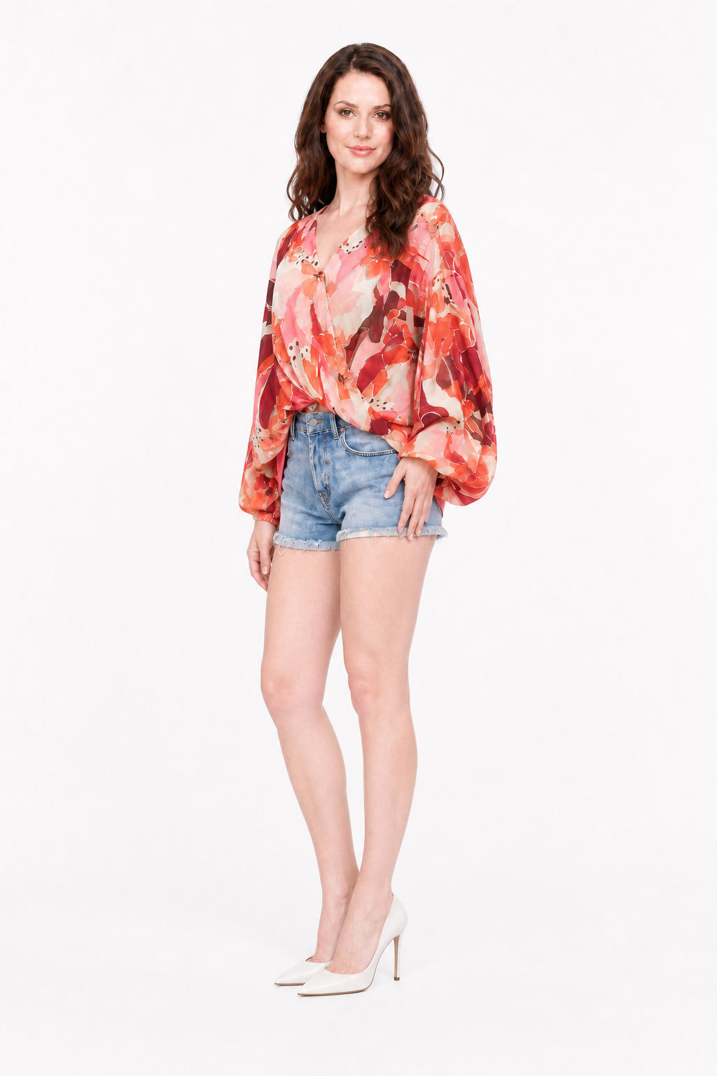 Love Me Lily floral wrap top three-quarter view with Zena in denim shorts and white heels.