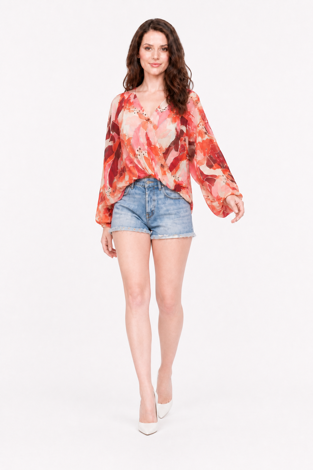 Love Me Lily floral wrap top walking view showing billowing sleeves, with denim shorts and white heels.