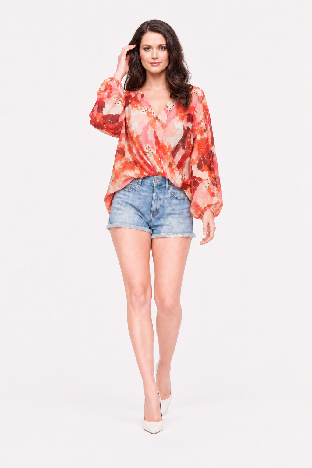 Love Me Lily floral wrap top walking studio view with Zena in denim shorts and white heels.