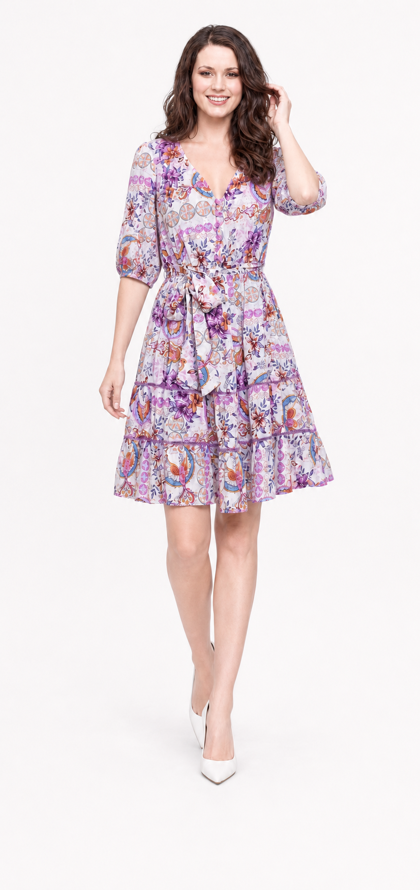 Zena wearing the Lovely Laven Mini dress walking with one hand in her hair.