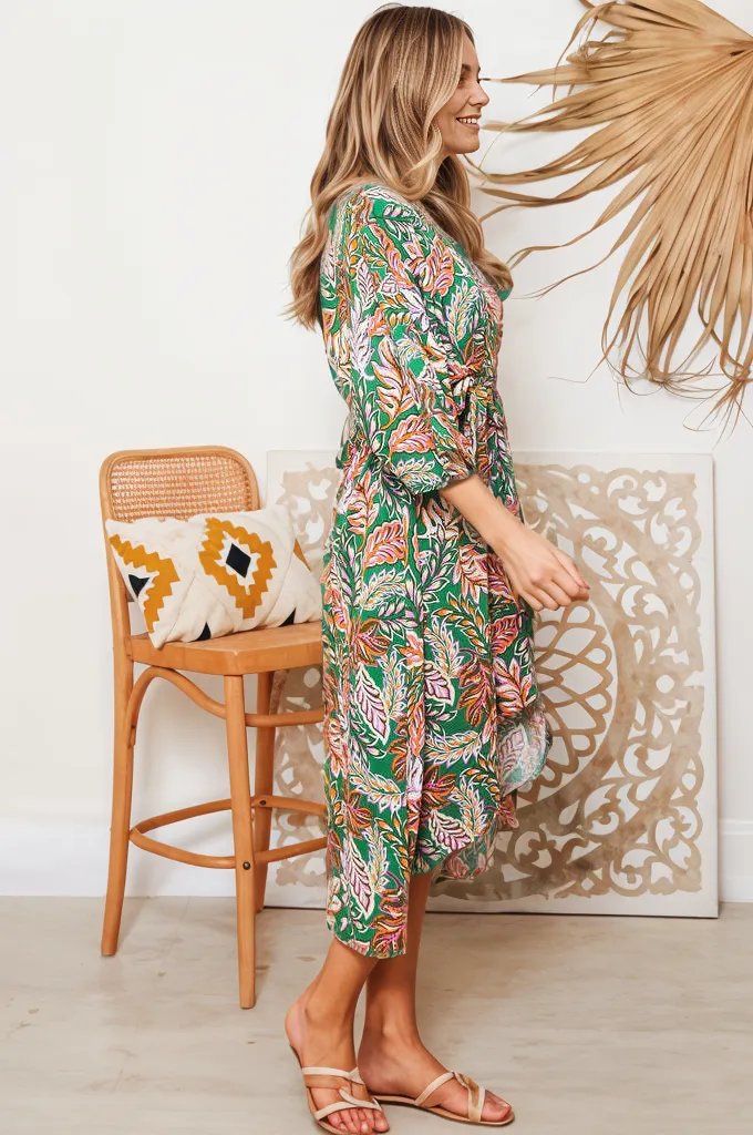 Woman wearing Boho Lane Australia Ziana Heena floral dress with green and pink leaf pattern standing indoors