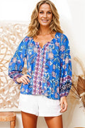 Boho Lane Australia model wearing blue floral Hana Fleur boho blouse with long sleeves and white shorts