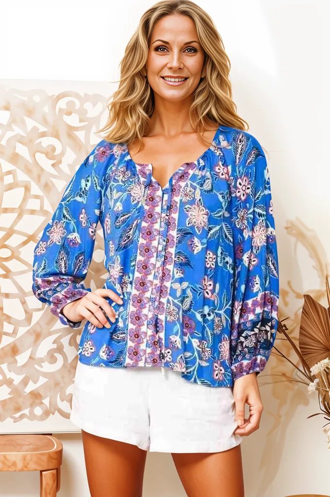 Boho Lane Australia model wearing blue floral Hana Fleur boho blouse with long sleeves and white shorts