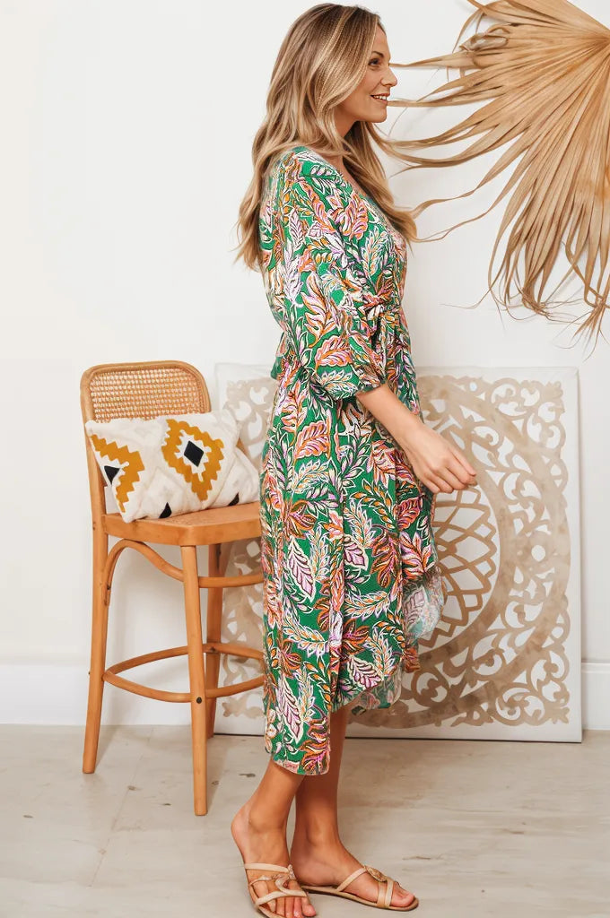 Side view of woman wearing Ziana Heena floral dress in green with pink and white botanical print
